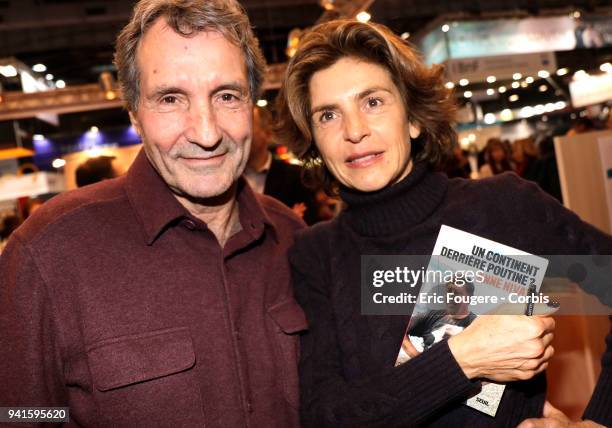 Journalist Jean-Jacques Bourdin and Reporter Anne Nivat poses during Paris Book Fair 2018 at Parc Des Expositions Porte de Versailles, France on .