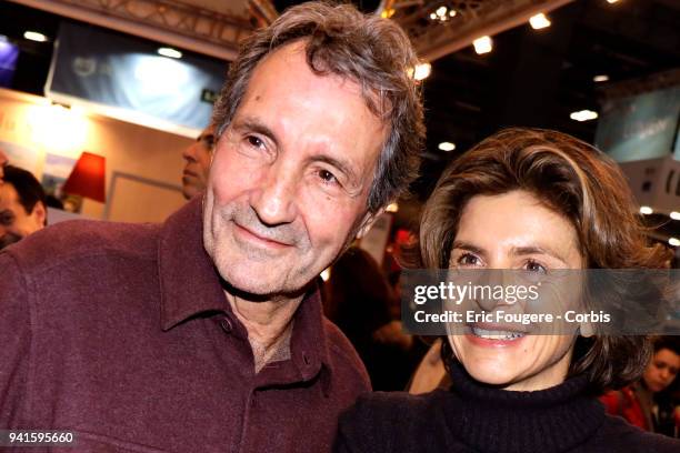 Journalist Jean-Jacques Bourdin and Reporter Anne Nivat poses during Paris Book Fair 2018 at Parc Des Expositions Porte de Versailles, France on .