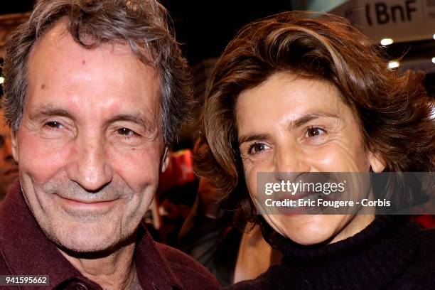 Journalist Jean-Jacques Bourdin and Reporter Anne Nivat poses during Paris Book Fair 2018 at Parc Des Expositions Porte de Versailles, France on .