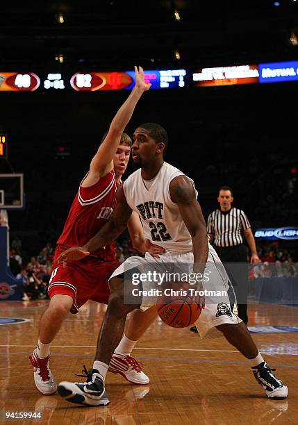 Brad Wanamaker of the Pitt Panthers drives past a defending Jordan Hulls of the Indiana Hoosiers during the Jimmy V Classic at Madison Square Garden...