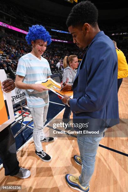 Gary Harris of the Denver Nuggets signs autograph for a fan during the game against the Milwaukee Bucks on April 1, 2018 at the Pepsi Center in...