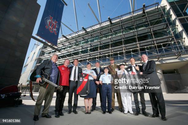 Mike Brady, Kevin Sheedy, Collingwood CEO Mark Anderson Essendon CEO, Xavier Campbell and Collingwood President Eddie McGuire pose with members of...