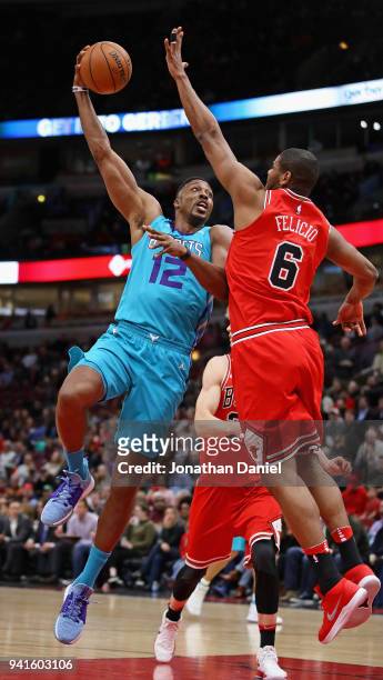 Dwight Howard of the Charlotte Hornets puts up a shot against Cristiano Felicio of the Chicago Bulls at the United Center on April 3, 2018 in...