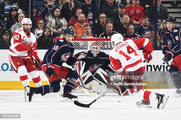 Goaltender Sergei Bobrovsky of the Columbus Blue Jackets defends the net as Alexander Wennberg of the Columbus Blue Jackets attempts to block a shot...