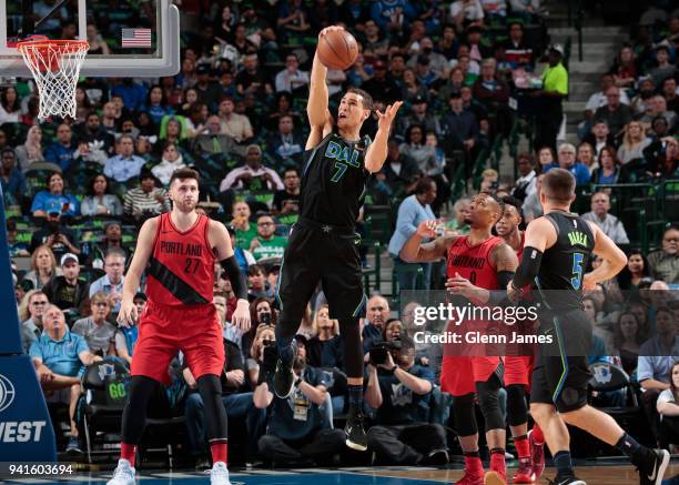 Dwight Powell of the Dallas Mavericks grabs the rebound against the Portland Trail Blazers on April 3, 2018 at the American Airlines Center in...