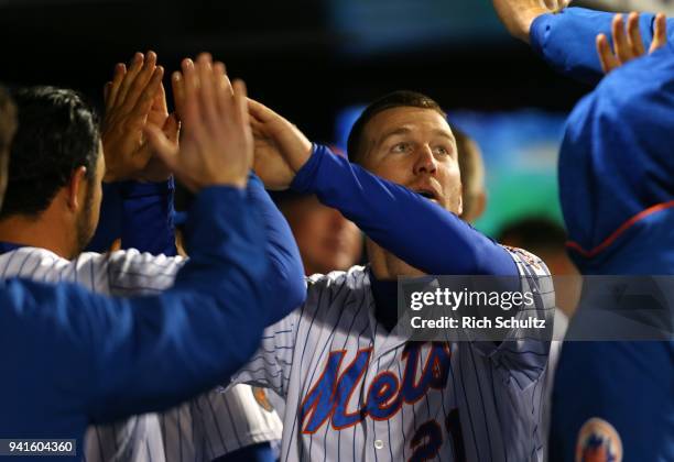 Todd Frazier of the New York Mets in congratulated by teammates after scoring on an RBI single by Travis d'Arnaud against the Philadelphia Phillies...