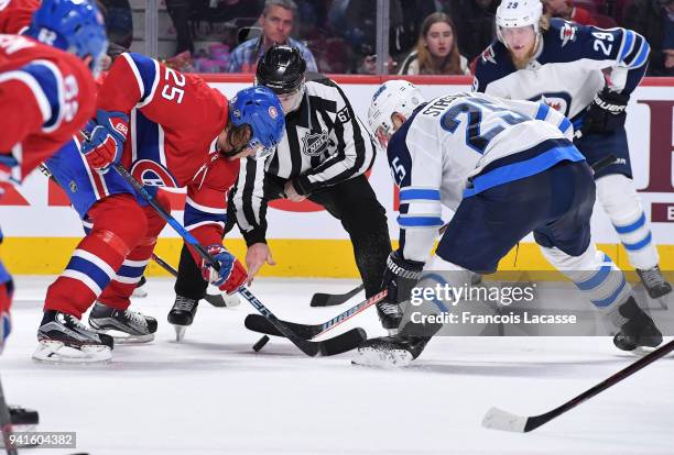 Jacob De La Rose of the Montreal Canadiens faces off against Paul Stastny of the Winnipeg Jets in the NHL game at the Bell Centre on April 3, 2018 in...