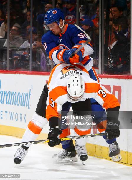 Ross Johnston of the New York Islanders checks Radko Gudas of the Philadelphia Flyers during the third period at Barclays Center on April 3, 2018 in...