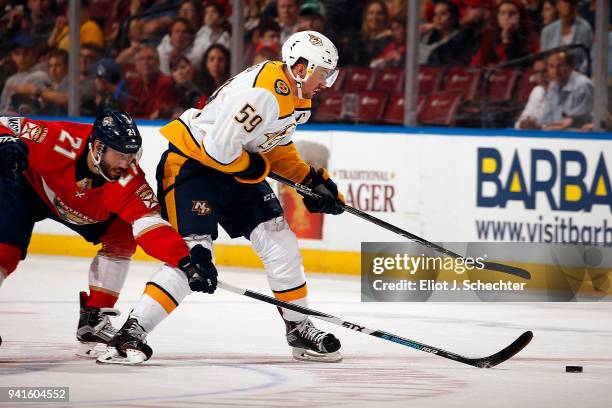 Roman Josi of the Nashville Predators skates for possession against Vincent Trocheck of the Florida Panthers at the BB&T Center on April 3, 2018 in...