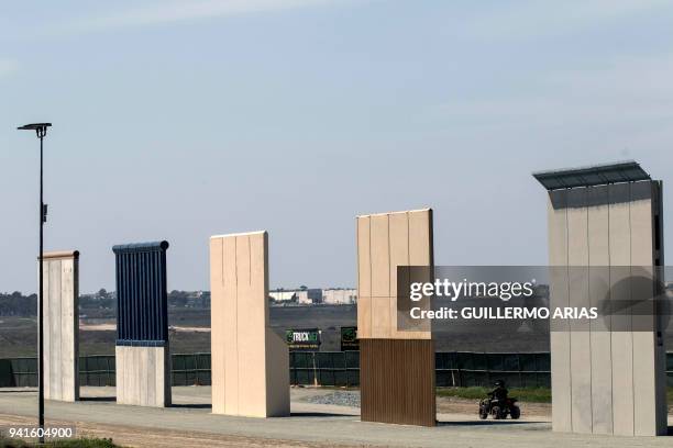 Border patrol quad is seen next to US President Donald Trump's border wall prototypes from Tijuana, northwestern Mexico, on April 3, 2018. President...