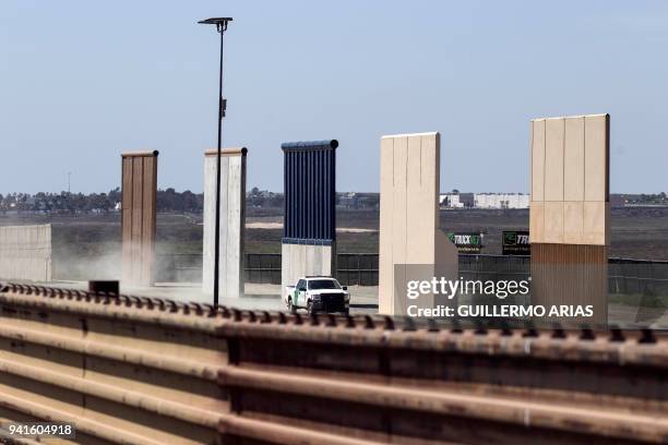 Border patrol truck is seen next to US President Donald Trump's border wall prototypes from the US-Mexico border in Tijuana, northwestern Mexico, on...