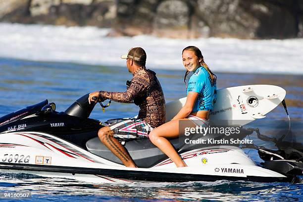 Carissa Moore of Hawaii catches a ride on the back of the water patrol jet ski after her heat at the Billabong Pro Maui on December 8, 2009 in...