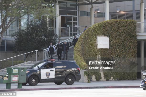 Security forces inspect the scene after they responded to an active shooter at YouTube's California headquarters in San Bruno, California, United...