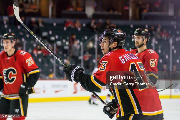 Johnny Gaudreau of the Calgary Flames shows his puck handling skills at warm up in an NHL game on April 3, 2018 at the Scotiabank Saddledome in...