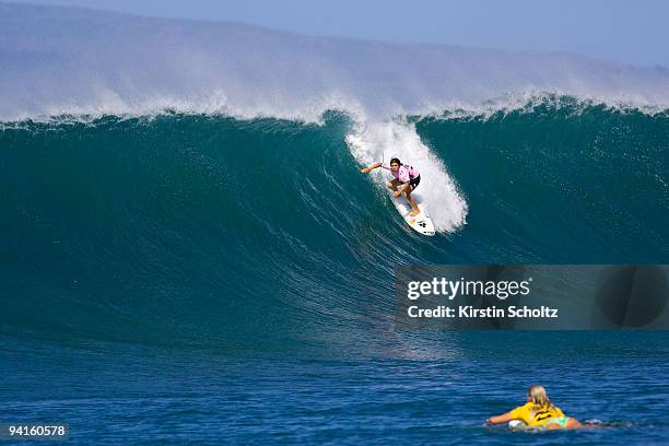 Sofia Mulanovich of Peru drops into a wave at the Billabong Pro Maui as her competitor Rosy Hodge of South Africa paddles back out on December 8,...