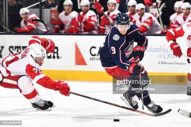 Dylan Larkin of the Detroit Red Wings reaches to knock the puck away from Artemi Panarin of the Columbus Blue Jackets during the third period of a...