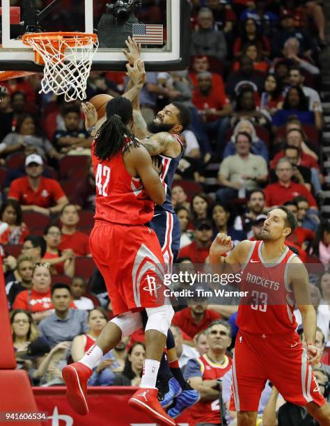 Markieff Morris of the Washington Wizards goes up for a shot against Nene Hilario and Ryan Anderson of the Houston Rockets in the first half at...