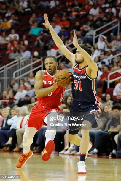 Eric Gordon of the Houston Rockets drives to the basket against Tomas Satoransky of the Washington Wizards in the first half at Toyota Center on...