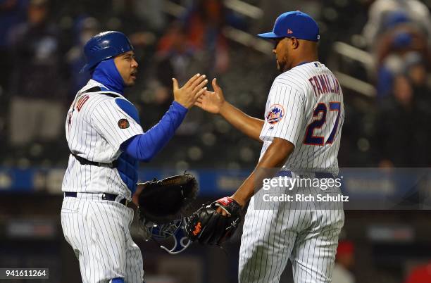 Catcher Travis d'Arnaud and closer Jeurys Familia of the New York Mets shake hands after getting the final out in the ninth inning of a game against...