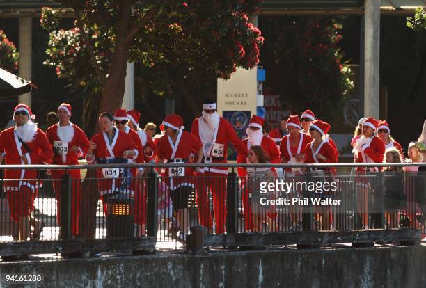 Competitors in the Great New Zealand Santa Run jog through the Viaduct Harbour on December 9, 2009 in Auckland, New Zealand. The run was held in an...