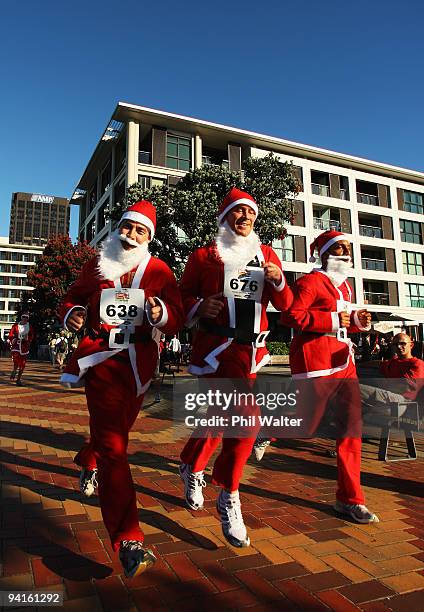 Competitors in the Great New Zealand Santa Run jog through the Viaduct Harbour on December 9, 2009 in Auckland, New Zealand. The run was held in an...