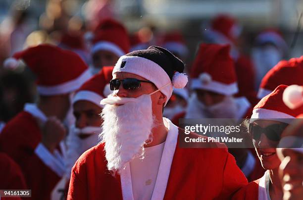 Competitors in the Great New Zealand Santa Run prepare to jog through the Viaduct Harbour on December 9, 2009 in Auckland, New Zealand. The run was...