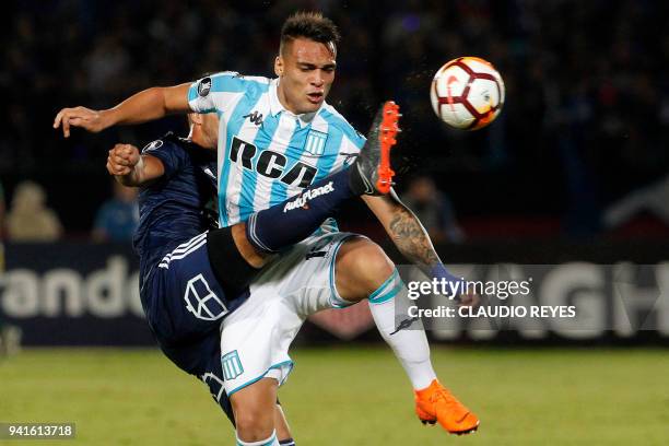 Chile's Universidad de Chile player Christian Vilches vies for the ball with Argentina's Racing Club forward Lautaro Martinez during their Copa...