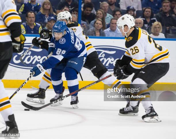 Cory Conacher of the Tampa Bay Lightning skates against Colby Cave of the Boston Bruins during the third period at Amalie Arena on April 3, 2018 in...