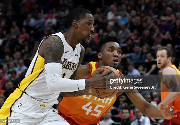 Kentavious Caldwell-Pope of the Los Angeles Lakers drives against the defense of Donovan Mitchell of the Utah Jazz in the first half of a game at...