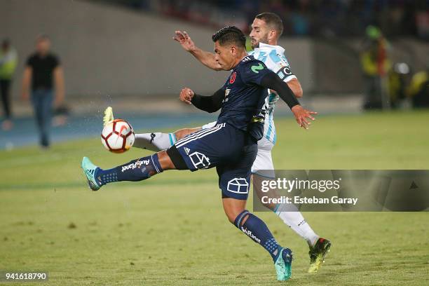 Gonzalo Jara of U de Chile fights for the ball with Lisandro Lopez of Racing Club during a match between U de Chile and Racing Club as part of Copa...