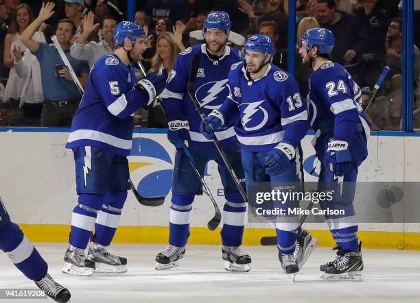 Members of the Tampa Bay Lightning, from left, Dan Girardi, Victor Hedman, Cedric Paquette and Ryan Callahan celebrate a goal against the Boston...