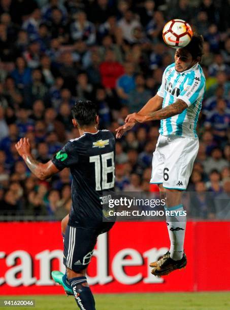 Chile's Universidad de Chile player Gonzalo Jara vies for the ball with Argentina's Racing Club forward Miguel Barbieri during their Copa...