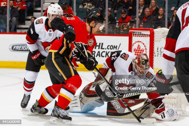 Mikael Backlund of the Calgary Flames attacks the net guarded by Antti Raanta of the Arizona Coyotes in an NHL game on April 3, 2018 at the...