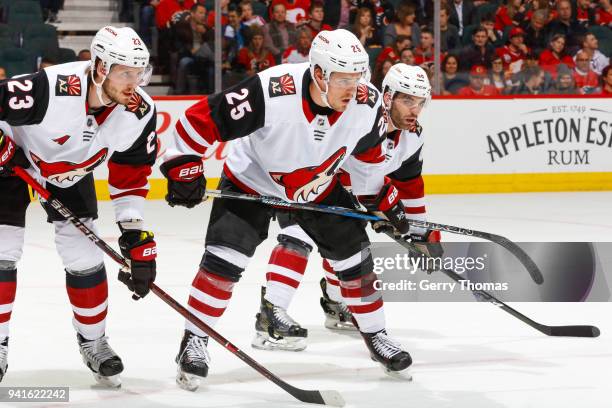 Oliver Ekman-Larsson, Nick Cousins, Jordan Martinook of the Arizona Coyotes at face off in an NHL game on April 3, 2018 at the Scotiabank Saddledome...