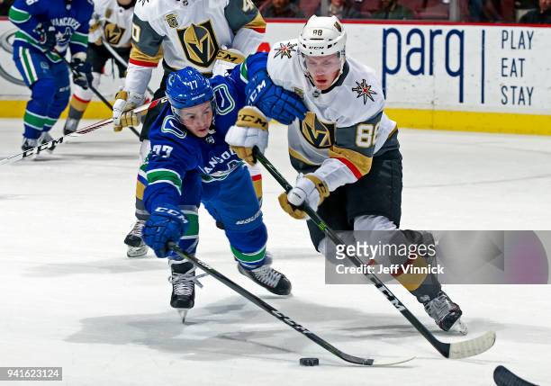 Nikolay Goldobin of the Vancouver Canucks checks Nate Schmidt of the Vegas Golden Knights during their NHL game at Rogers Arena April 3, 2018 in...