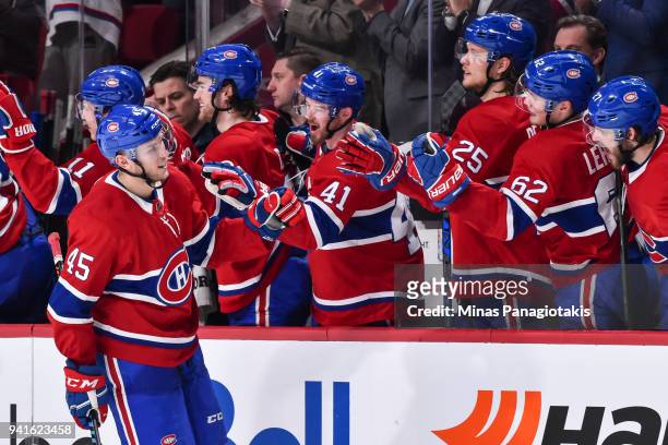 Kerby Rychel of the Montreal Canadiens celebrates his first goal of the season with teammates on the bench against the Winnipeg Jets during the NHL...