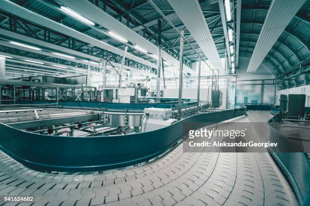 production line and machines in water bottling factory - modern laboratory stock pictures, royalty-free photos & images