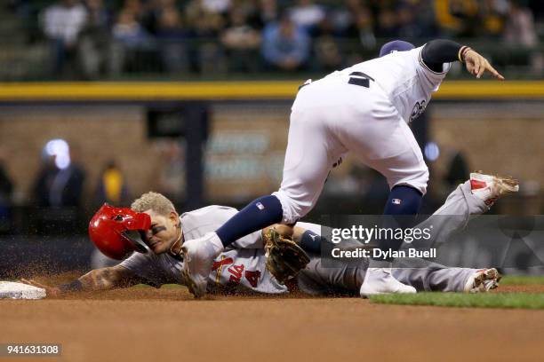 Yadier Molina of the St. Louis Cardinals steals second base past Jonathan Villar of the Milwaukee Brewers in the eighth inning at Miller Park on...