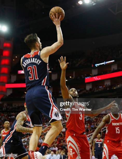 Tomas Satoransky of the Washington Wizards goes up for a shot defended by Chris Paul of the Houston Rockets in the second half at Toyota Center on...