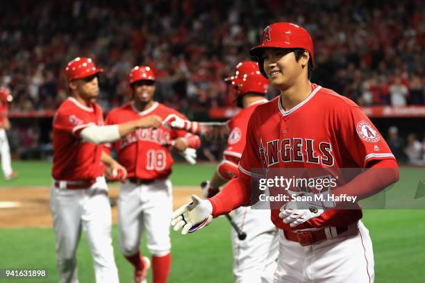 Luis Valbuena, and Andrelton Simmons congratulate Shohei Ohtani of the Los Angeles Angels of Anaheim after his three-run homerun during the first...