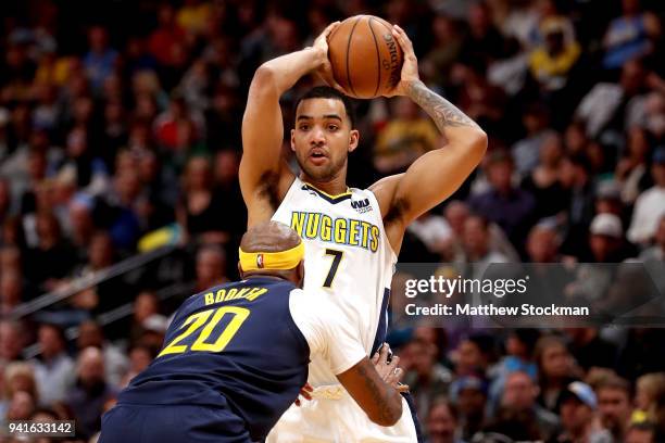 Trey Lyles of the Denver Nuggets looks for an outlet pass while being guarded by Trevor Booker of the Indiana Pacers at the Pepsi Center on April 3,...