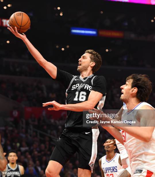 Pau Gasol of the San Antonio Spurs drives past Boban Marjanovic of the Los Angeles Clippers for a basket in the first half of the game at Staples...