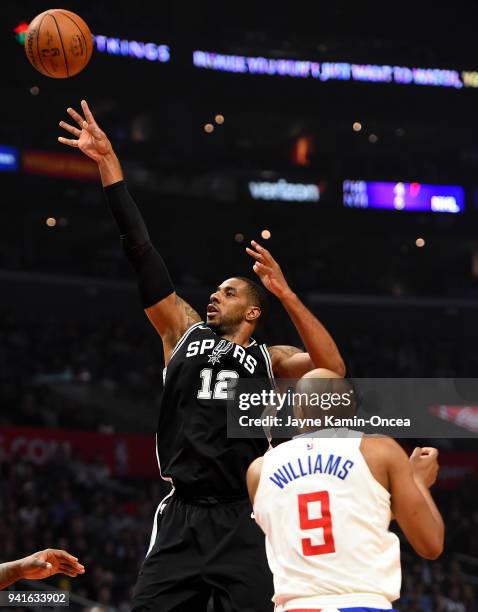 LaMarcus Aldridge of the San Antonio Spurs shoots over C.J. Williams of the Los Angeles Clippers for a basket in the first half of the game at...