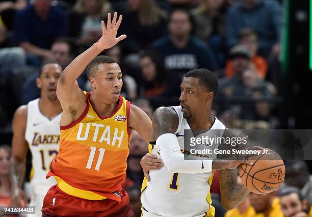 Dante Exum of the Utah Jazz guards Kentavious Caldwell-Pope of the Los Angeles Lakers in the second half of a game at Vivint Smart Home Arena on...