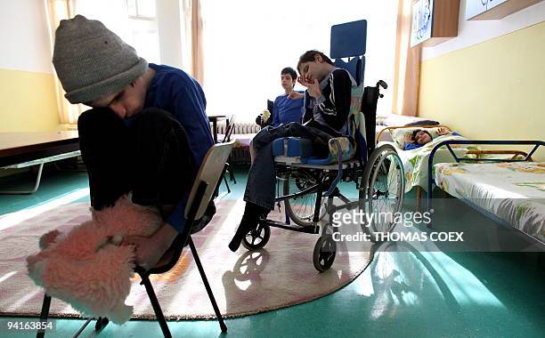 Disabled and orphaned Romanian adults are pictured in their room on November 26 at the Babeni orphanage, southwestern Romania. Twenty years after the...
