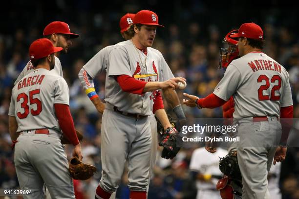 Manager Mike Matheny of the St. Louis Cardinals relieves Miles Mikolas in the sixth inning against the Milwaukee Brewers at Miller Park on April 2,...