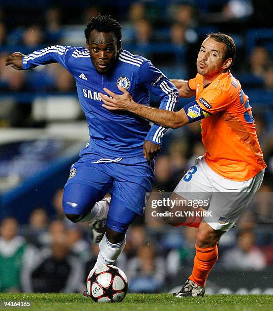 Chelsea's Ghanaian midfielder Michael Essien vies with Apoel Nicosia's Cypriot midfielder Chrysostomos Michail during their UEFA Champions League...