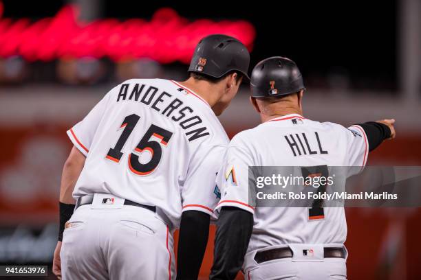Brian Anderson of the Miami Marlins talks with first base coach Perry Hill during the game against the Boston Red Sox at Marlins Park on April 2,...