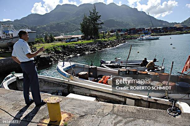 Lieutenant-Colonel Michael Rosette , the commanding officer of the Seychellois coast guard, looks on November 28, 2009 at two outboard motor large...
