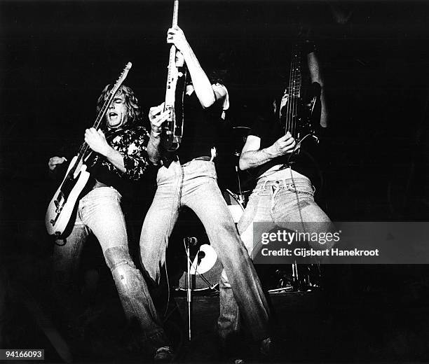 Status Quo perform live on stage at Ahoy, Rotterdam, Holland on August 15 1976. L-R Rick Parfitt, Francis Rossi, Alan Lancaster